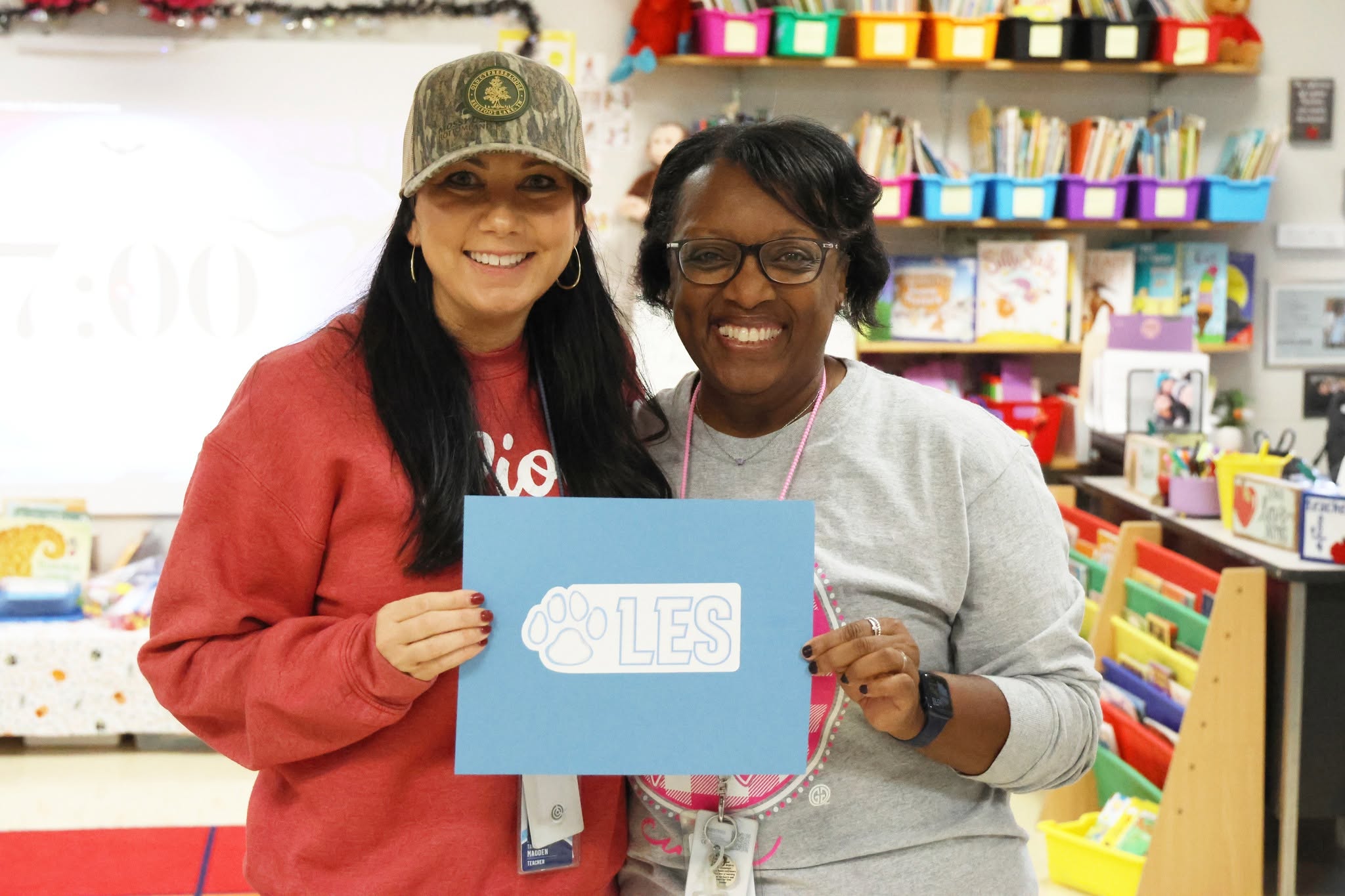 Tammy Madden and LES Principal Joretha Lockhart hold an LES sign in Madden’s kindergarten classroom.